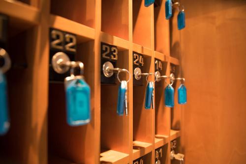 a row of lockers with blue tags on them at Hotel Toggenburgerhof in Kirchberg