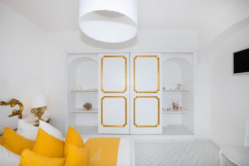 a living room with yellow pillows and a window at Villa Yiara in Positano