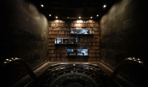 a dark room with a hot tub in the middle at Avenue Lodge Hotel & Spa in Val-d'Isère