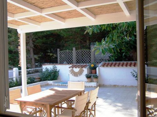 an outdoor patio with a wooden table and chairs at Delizioso appartamento isole Tremiti in San Domino