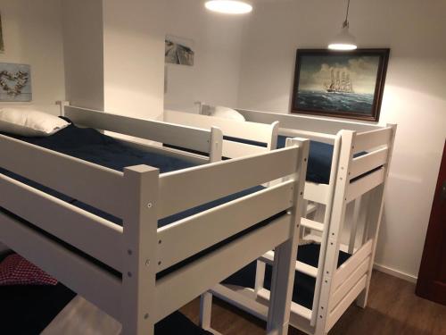 two bunk beds in a room with a bed at Landhaus zum Storchennest in Kloster Wulfshagen