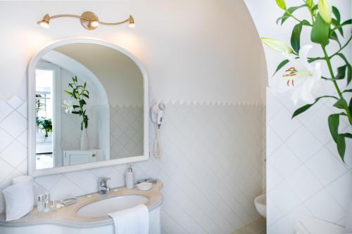 a bathroom with a sink and a mirror at Villa Yiara in Positano