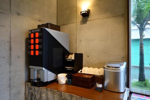 a coffee machine sitting on a counter next to a window at The BREAKFAST HOTEL PORTO Ishigakijima in Ishigaki Island