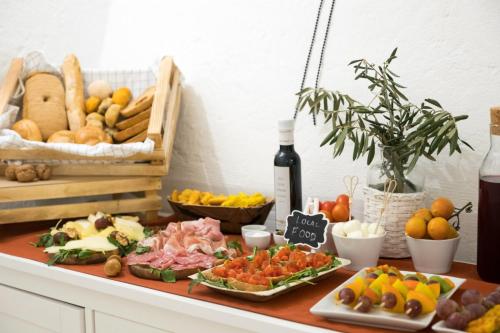 a table topped with different types of fruits and vegetables at Amatè Suite in Lecce