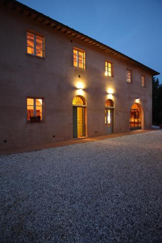 a large house with lights on the side of it at Agriturismo Podere La Casa in Palaia