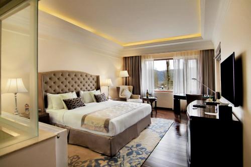 a hotel room with a bed and a living room at The Indus Valley in Leh