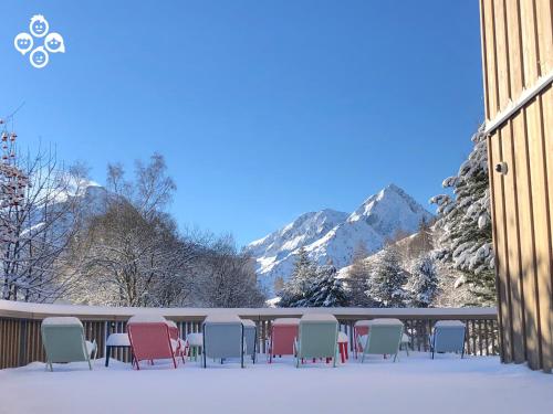 a group of chairs sitting on a deck in the snow at The People - Les 2 Alpes in Les Deux Alpes