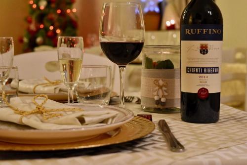 a table with a bottle of wine and a glass at Podere Belvedere in Barberino di Mugello