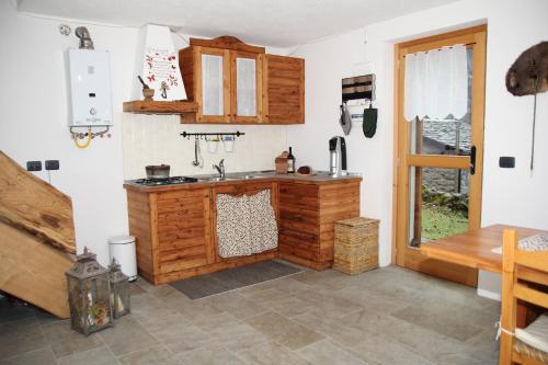 a kitchen with a sink and a counter top at Baite La Pedruscia in Val Masino