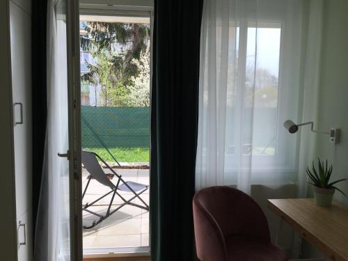 a living room with a chair and a window at Best Choice Terrace FREE Parking in Graz