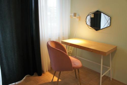a chair and a lamp in a room at Best Choice Terrace FREE Parking in Graz