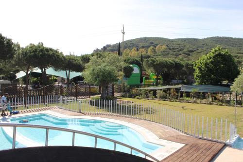 a small swimming pool with a fence around it at Camping Lacona Pineta in Capoliveri