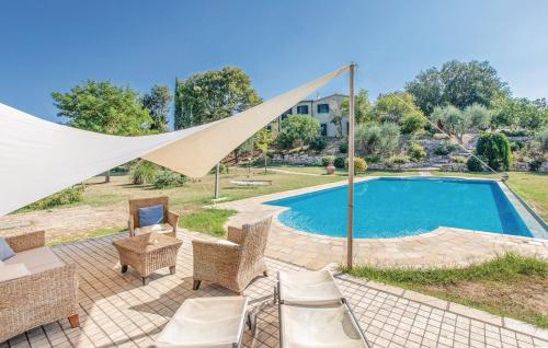 an image of a swimming pool with chairs and a tent at Podere Macee Casavacanza in Baschi