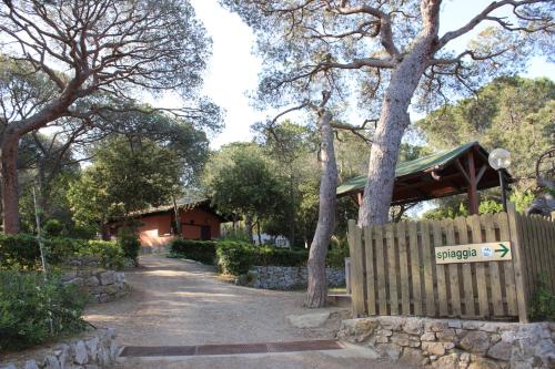 a gate to a house with a fence at Camping Lacona Pineta in Capoliveri