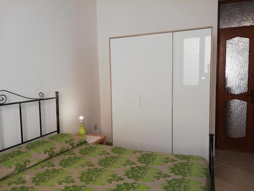 a bedroom with a bed and a sliding glass door at APPARTAMENTO IN CENTRO in Marsala
