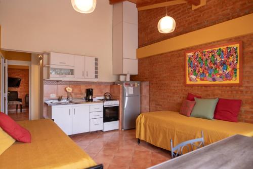 una pequeña cocina con 2 camas en una habitación en Samaná Departamentos en El Bolsón