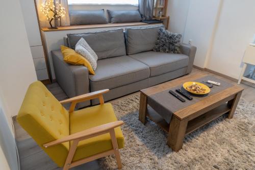 a living room with a couch and a table and a chair at Jumi in Belgrade