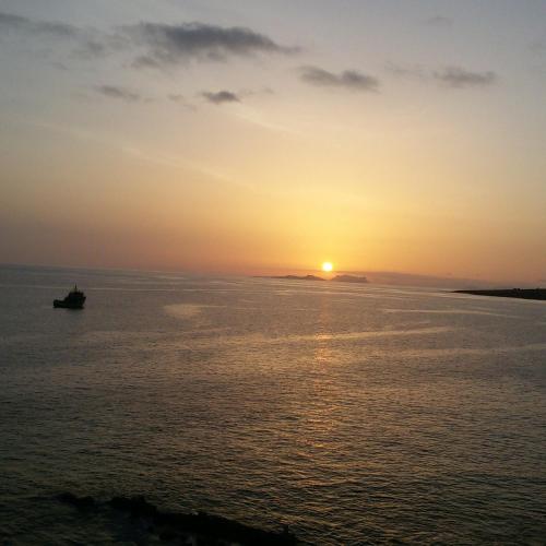 a boat in the ocean at sunset at bed & breakfast Regina in Tarrafal