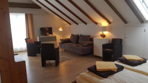 a living room with a couch and a living room with at BellaRosa in Emmetten