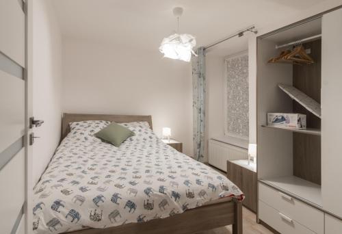 Posteľ alebo postele v izbe v ubytovaní Apartamenty W Starym Ogrodzie