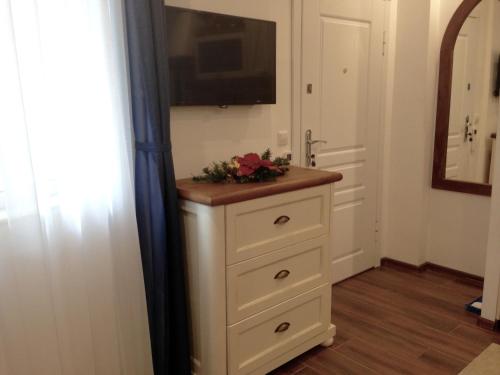 a bathroom with a dresser with a television on it at Guest Rooms Boutique Varna in Varna City