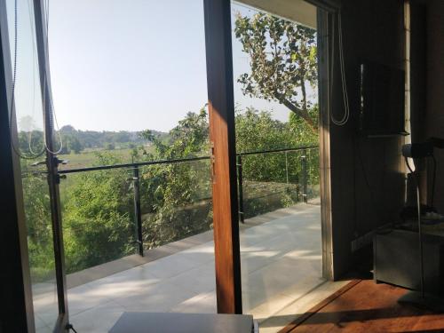 an open door to a balcony with a view at Luxurious 2BHK for Ultimate Holiday Experience in Goa - 2 in Candolim