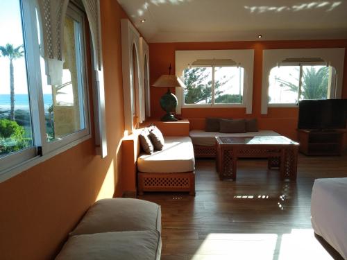 a living room with a couch and a table at Beach Hotel Dos Mares in Tarifa