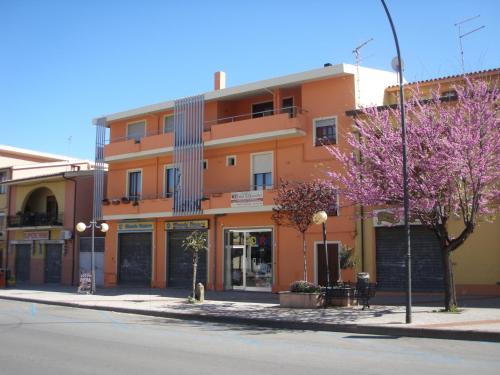an orange building on the side of a street at Il Leccio in Tortolì