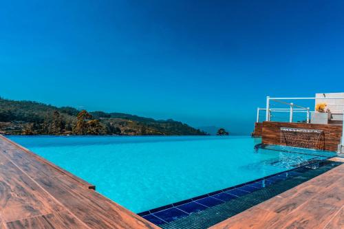 a view of a large pool of blue water at Hilldale Retreat in Nuwara Eliya
