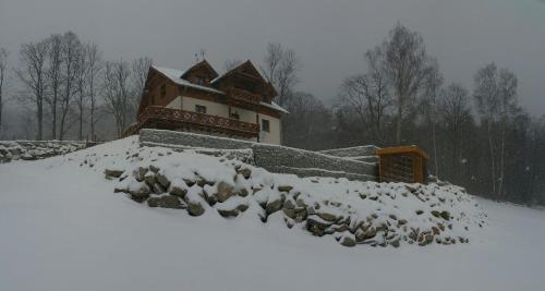 a pile of snow in front of a house at Uroczysko starych sztolni in Szklarska Poręba