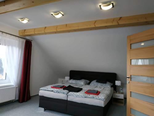 a bedroom with a bed with red towels on it at Bílá hora Štramberk in Štramberk