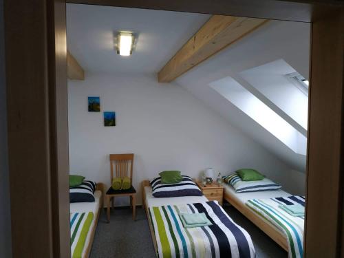 two beds in a room with a attic at Bílá hora Štramberk in Štramberk