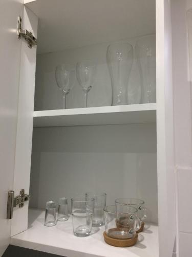 a cupboard filled with glasses sitting on top at Studio Fibra Doppio in Rybnik