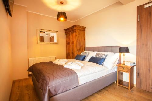 a bedroom with a large bed in a room at Willa Ostoja Wellness in Świeradów-Zdrój