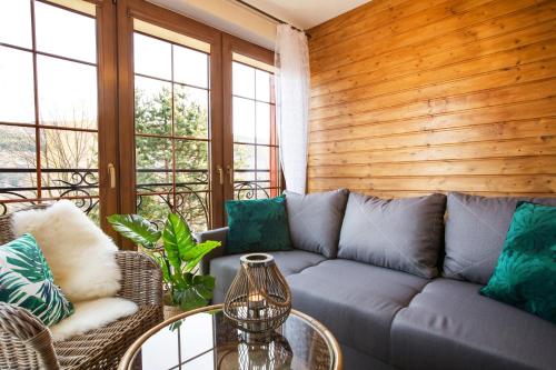 a living room with a couch and a table at Willa Ostoja Wellness in Świeradów-Zdrój