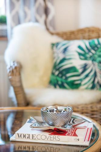 a coffee table with a bowl on top of a book at Willa Ostoja Wellness in Świeradów-Zdrój