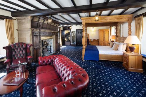 a hotel room with a couch and a bed at Bagdale Hall in Whitby