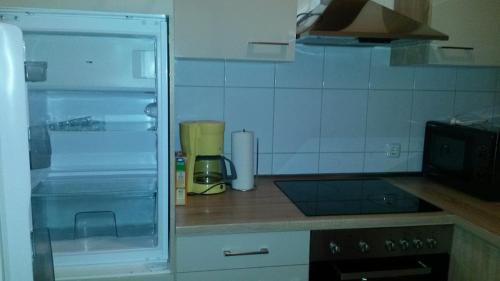 オーバーハウゼンにあるFerienwohnung Klausのキッチン(オープン冷蔵庫付きのカウンタートップ付)