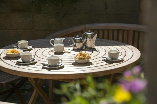 a table with cups and bowls of food on it at Bagdale Hall in Whitby