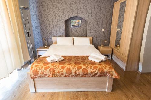 a bedroom with a bed with two towels on it at Alazani Valley Hotel in Telavi