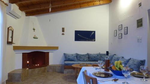 a living room with a table and a fireplace at Theathina in Kalamaki Heraklion