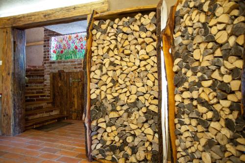 a pile of fire wood next to a wall at Siedlisko Wigry in Rosochaty Róg