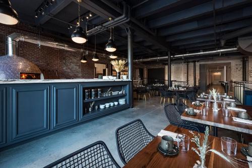 a restaurant with blue cabinets and tables and chairs at Crossroads Hotel in Kansas City