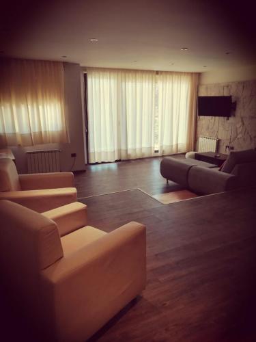 a large living room with couches and a television at Amarras in Villa Pehuenia