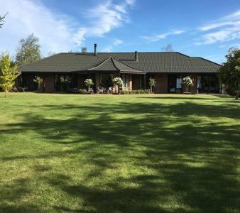 a large house with a large yard in front of it at Chester Oaks B&B in West Melton