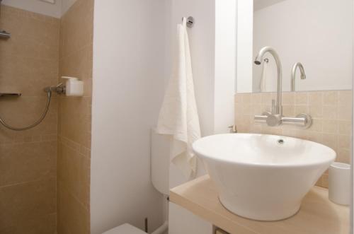 a bathroom with a white sink and a shower at MBM Studio Piata Romana Square in Bucharest