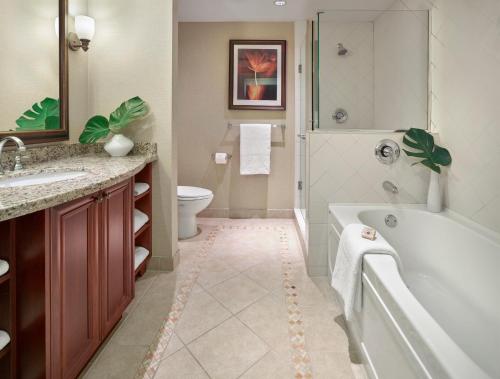 a bathroom with a tub and a toilet and a sink at Residences at the Sun Peaks Grand in Sun Peaks