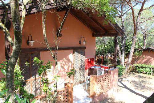a patio of a house with a porch at Camping Lacona Pineta in Capoliveri
