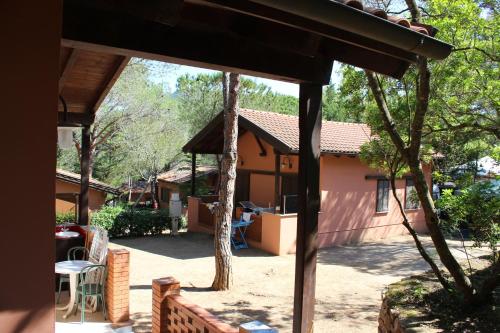 a view of a house from the backyard at Camping Lacona Pineta in Capoliveri