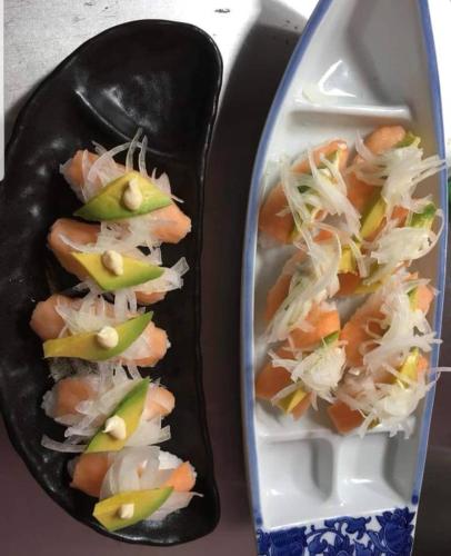 two plates of food with shrimp and vegetables at White Summerville Tourist Inn in Busuanga